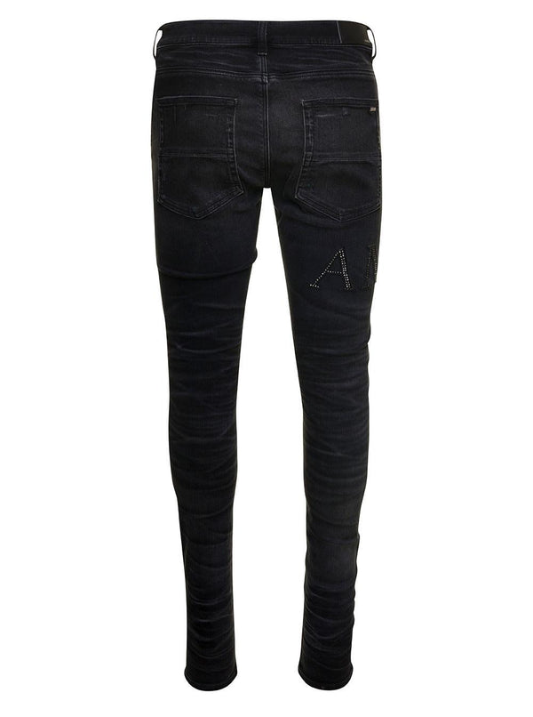 AMIRI Black Skinny Jeans With Crystal Embellished Logo And Used Effect In Stretch Cotton Denim Man - Men - Piano Luigi